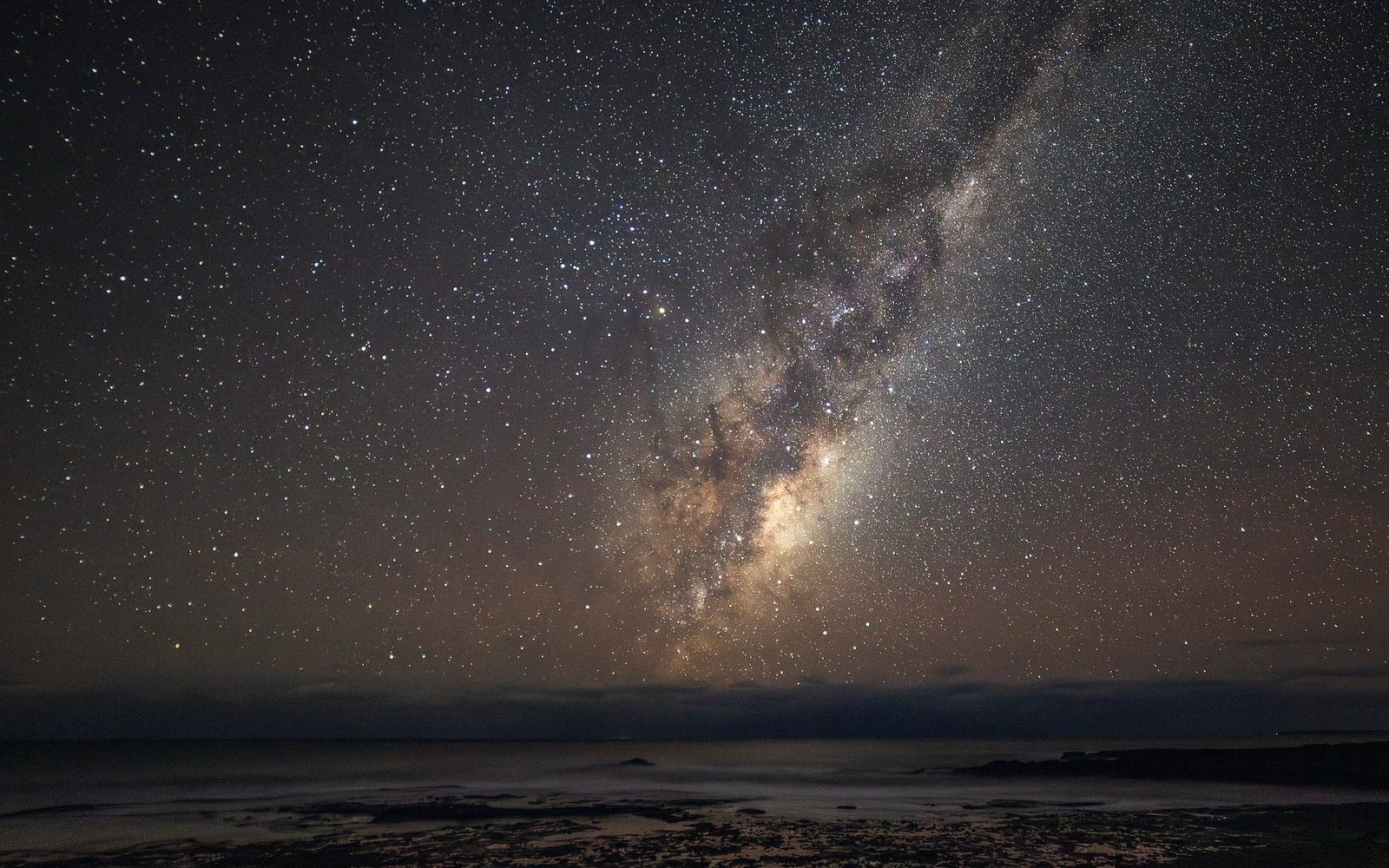 A dark sky over a low horizon with the Milky Way rising
